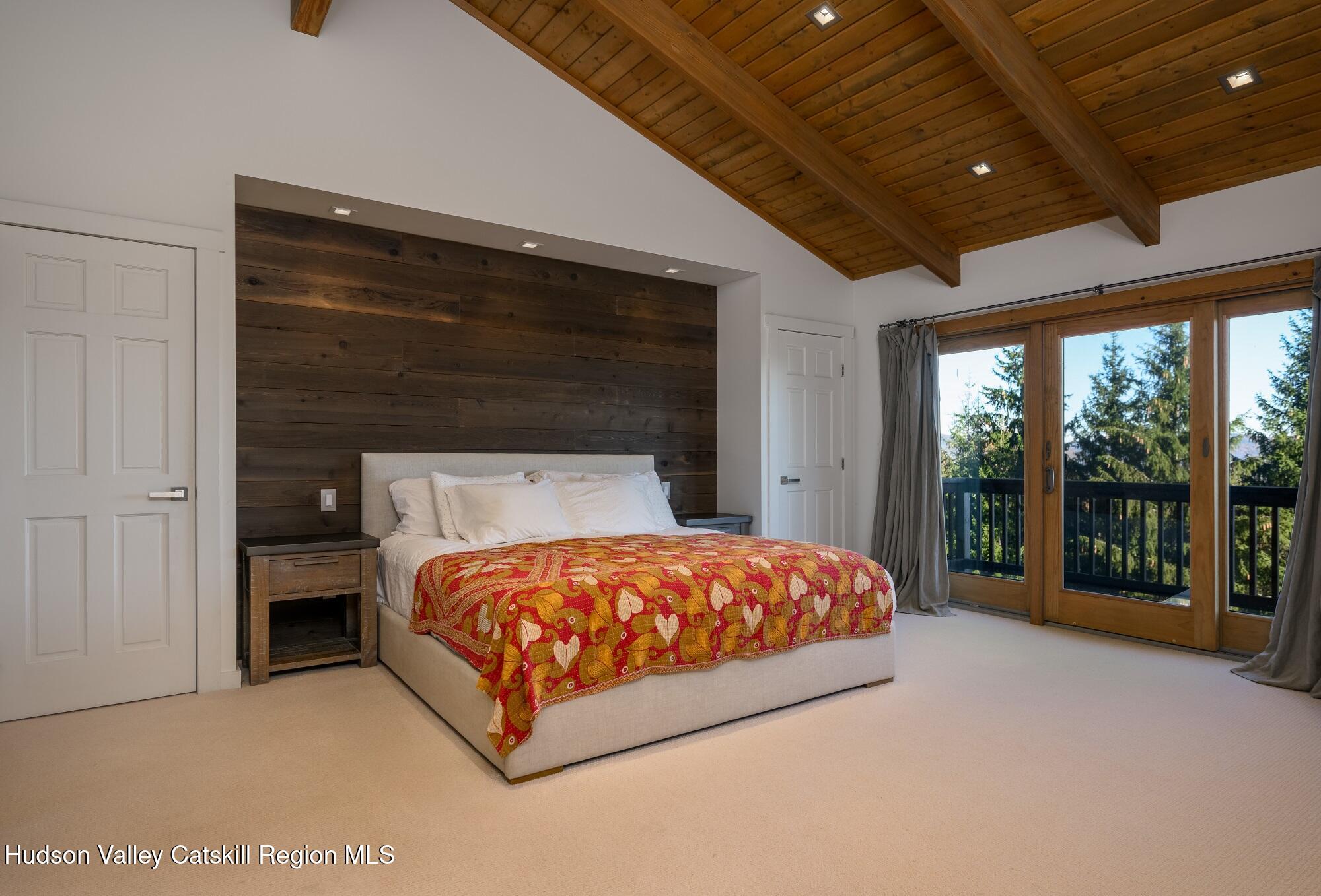 209 Club Road Windham, NY 12496 - Photo 7 of 18 a bed sitting in a spacious bedroom next to a window