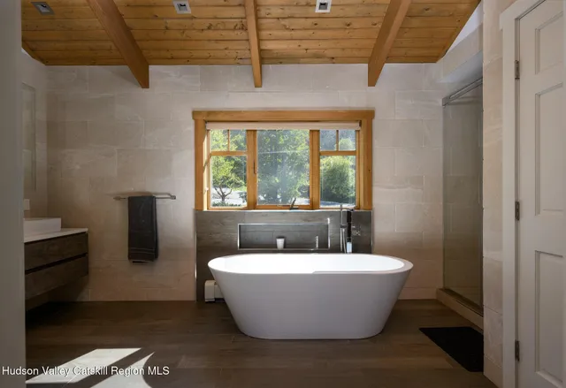 a bedroom with a large bed and a large window