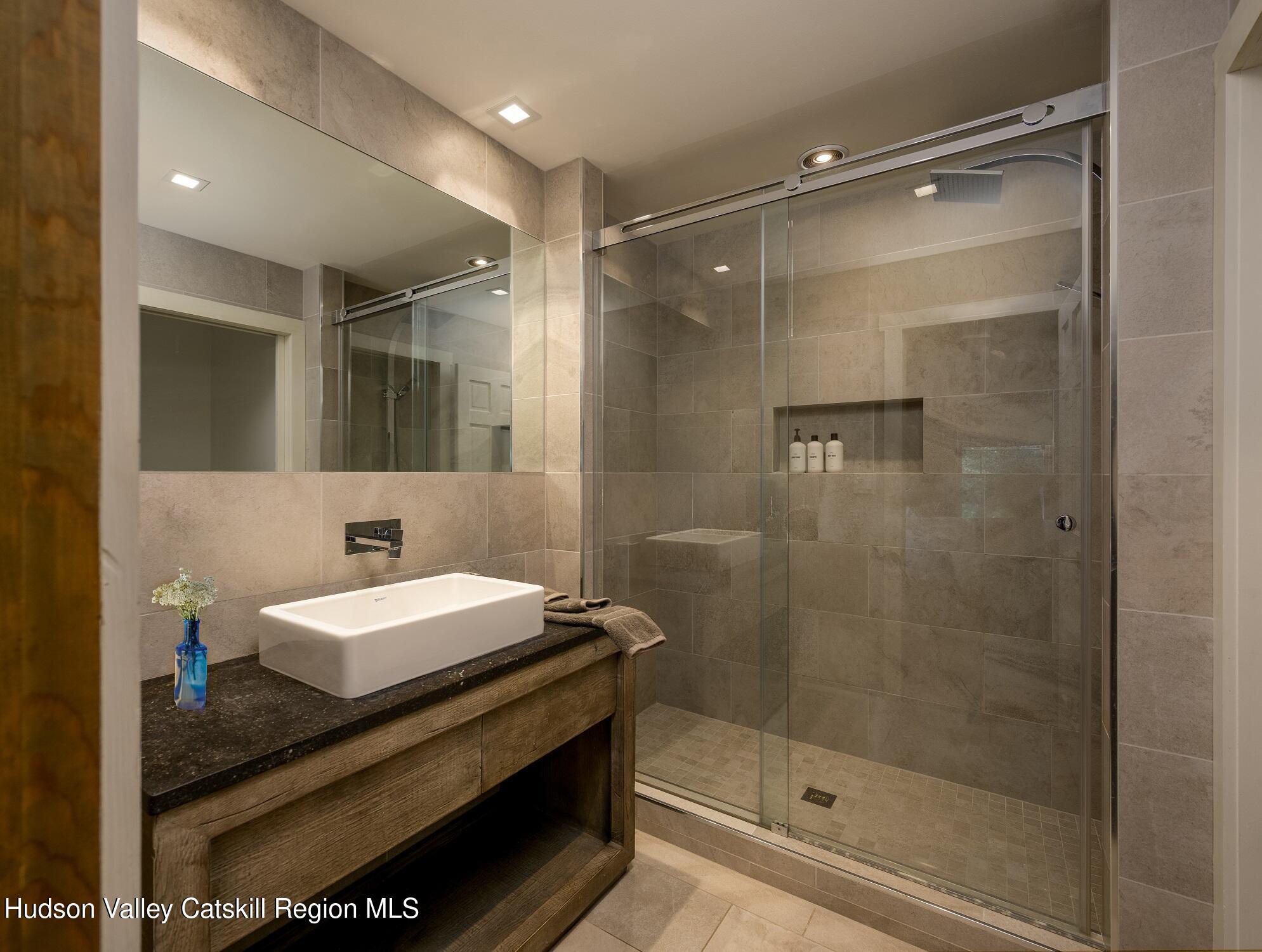209 Club Road Windham, NY 12496 - Photo 10 of 18 a bathroom with a sink and a mirror