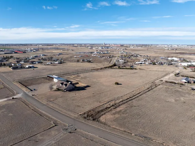 a large kitchen with stainless steel appliances granite countertop a stove a sink dishwasher and a microwave oven with white cabinets