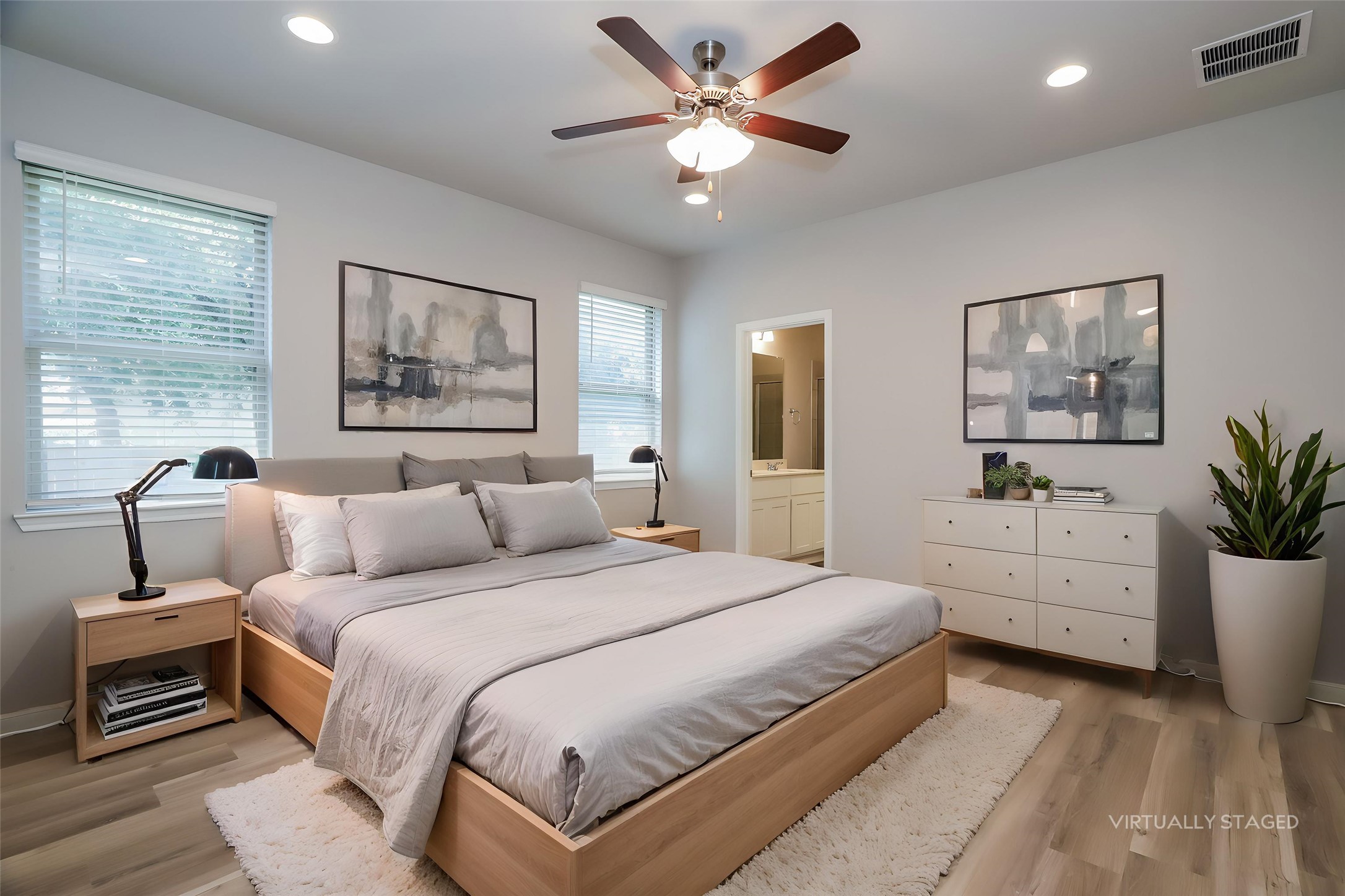 2724 Juniper Woods Road Leander, TX 78641 - Photo 3 of 21 Recessed lighting and a ceiling fan illuminate this calm, inviting bedroom space with light-toned flooring.