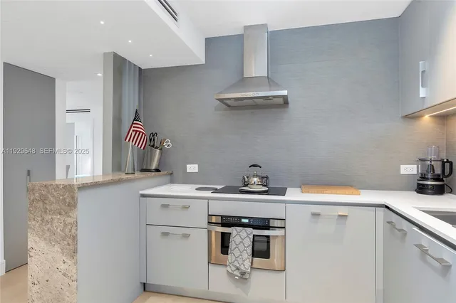 a kitchen with stainless steel appliances a sink a stove and refrigerator