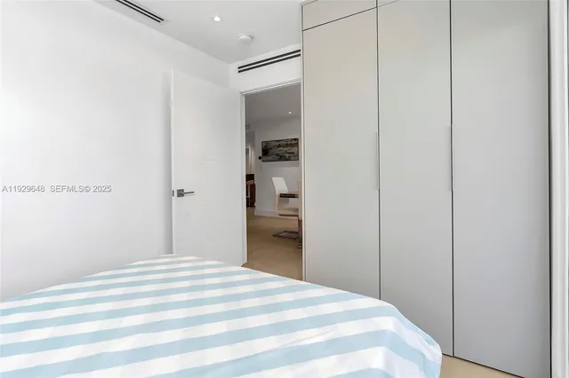 a bedroom with a bed and a mirror