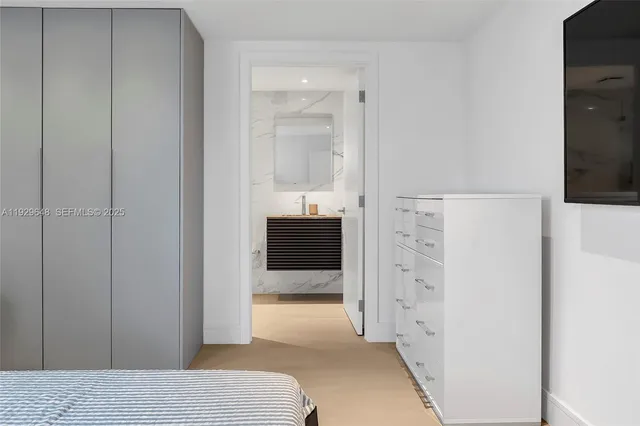 a bedroom with a bed and a sink