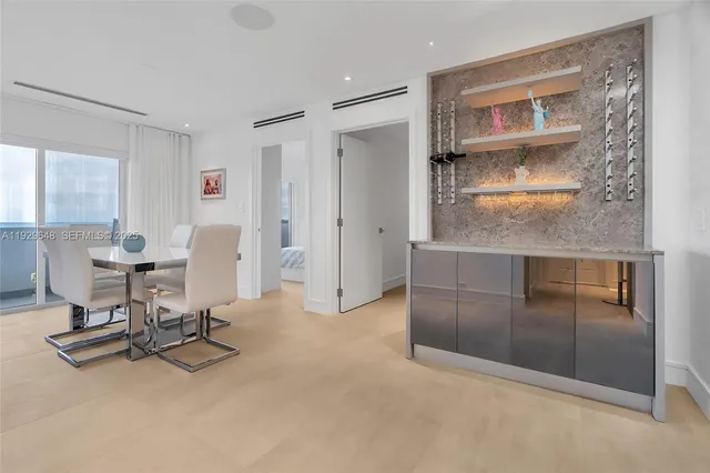 a view of a livingroom with workspace and a window