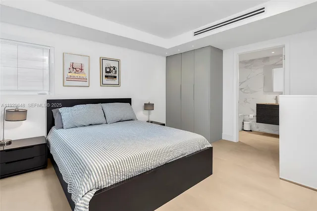 a bedroom with a bed and a couch