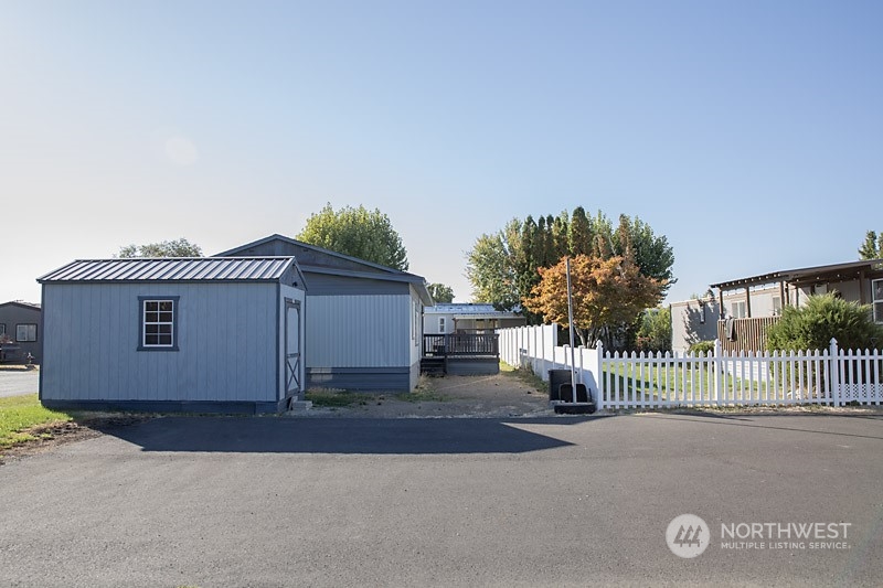 3005 Castlevale Road, Unit 31 Yakima, WA 98902 - Photo 4 of 19 a front view of a house with a yard and garage