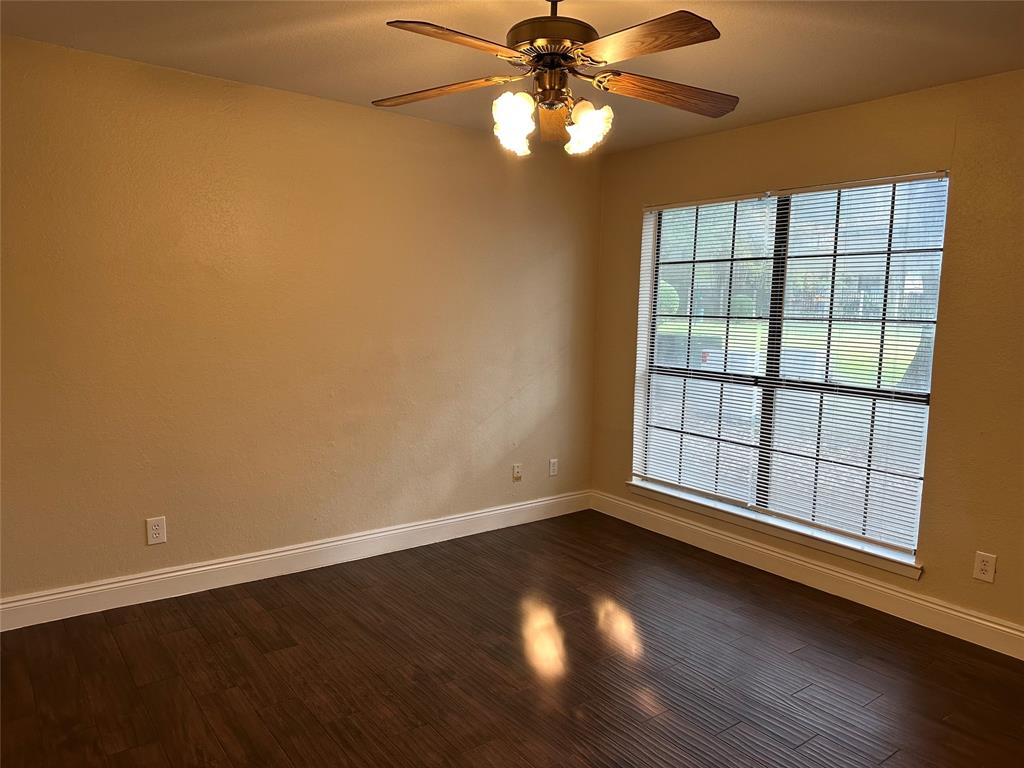 336 Melrose Drive, Unit 7B Richardson, TX 75080 - Photo 14 of 18 Spare room with ceiling fan and dark wood-style floors