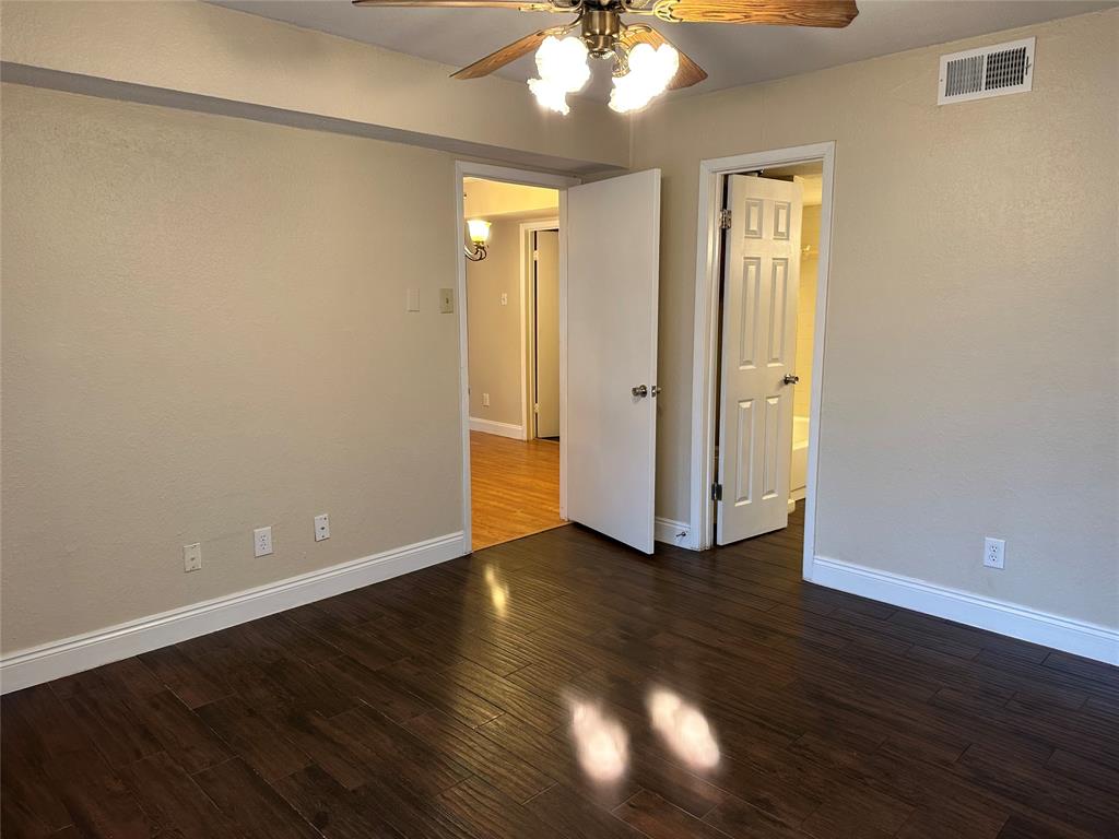 336 Melrose Drive, Unit 7B Richardson, TX 75080 - Photo 15 of 18 Empty room featuring a ceiling fan and wood finished floors