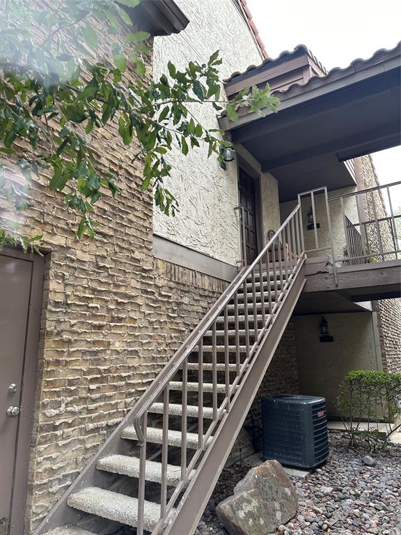 336 Melrose Drive, Unit 7B Richardson, TX 75080 - Photo 2 of 18 View of home's exterior featuring stairs and stucco siding