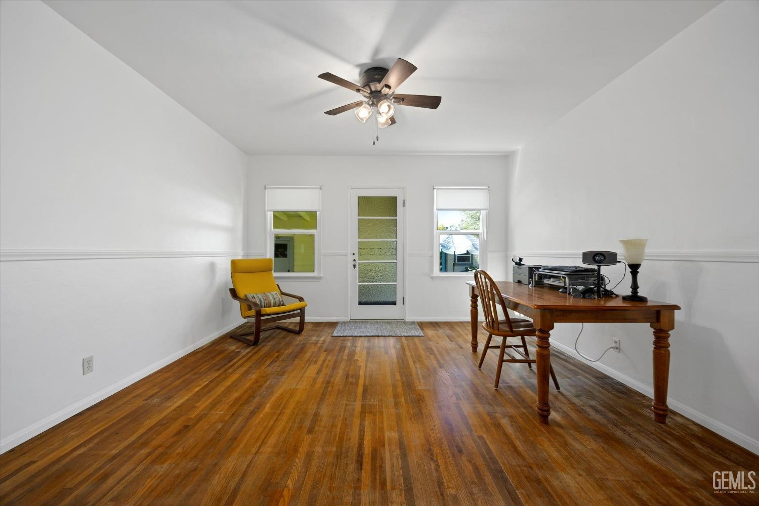 Undisclosed Address Bakersfield, CA 93305 - Photo 11 of 39 a living room with furniture and a wooden floor