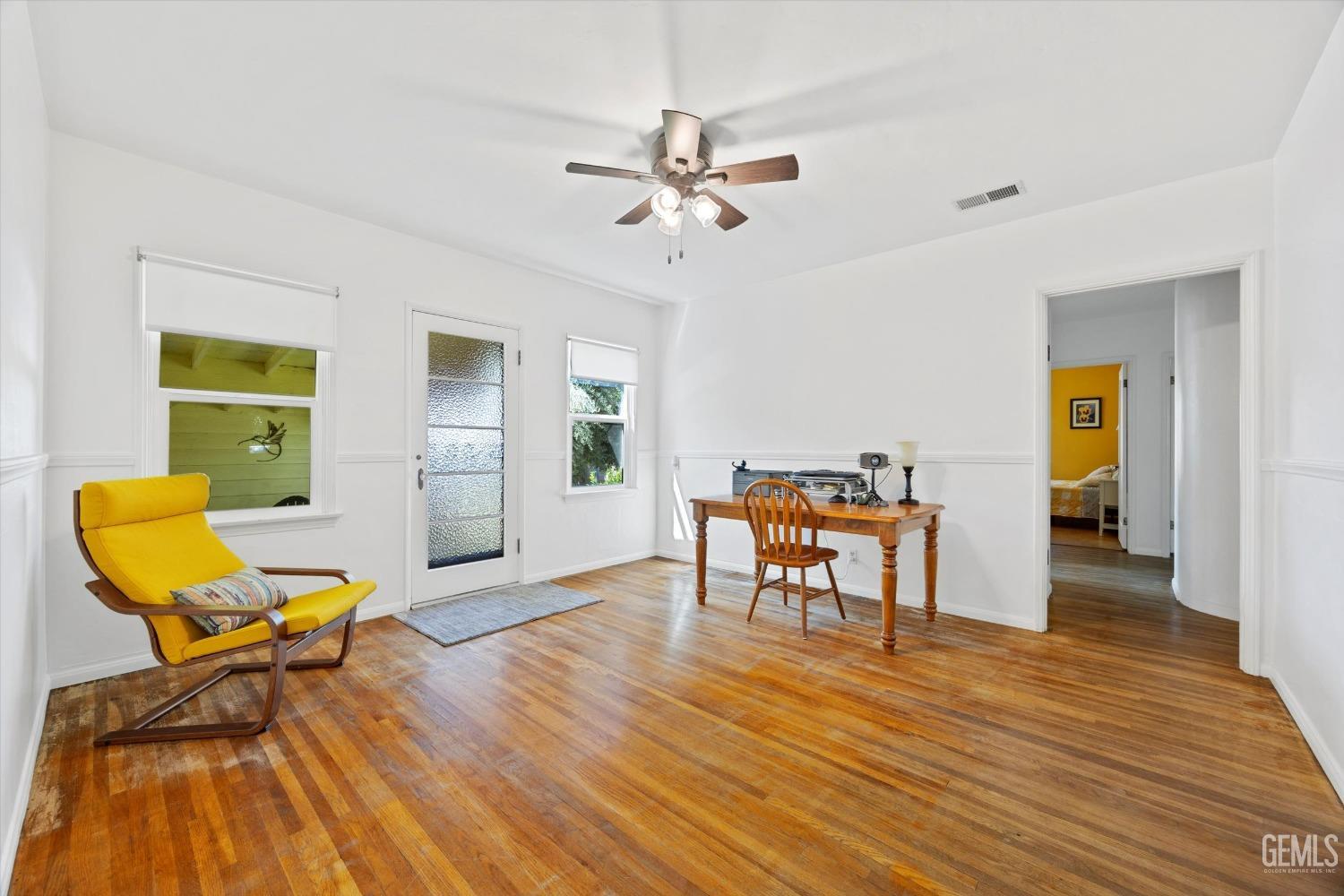 Undisclosed Address Bakersfield, CA 93305 - Photo 12 of 39 a living room with furniture and a wooden floor