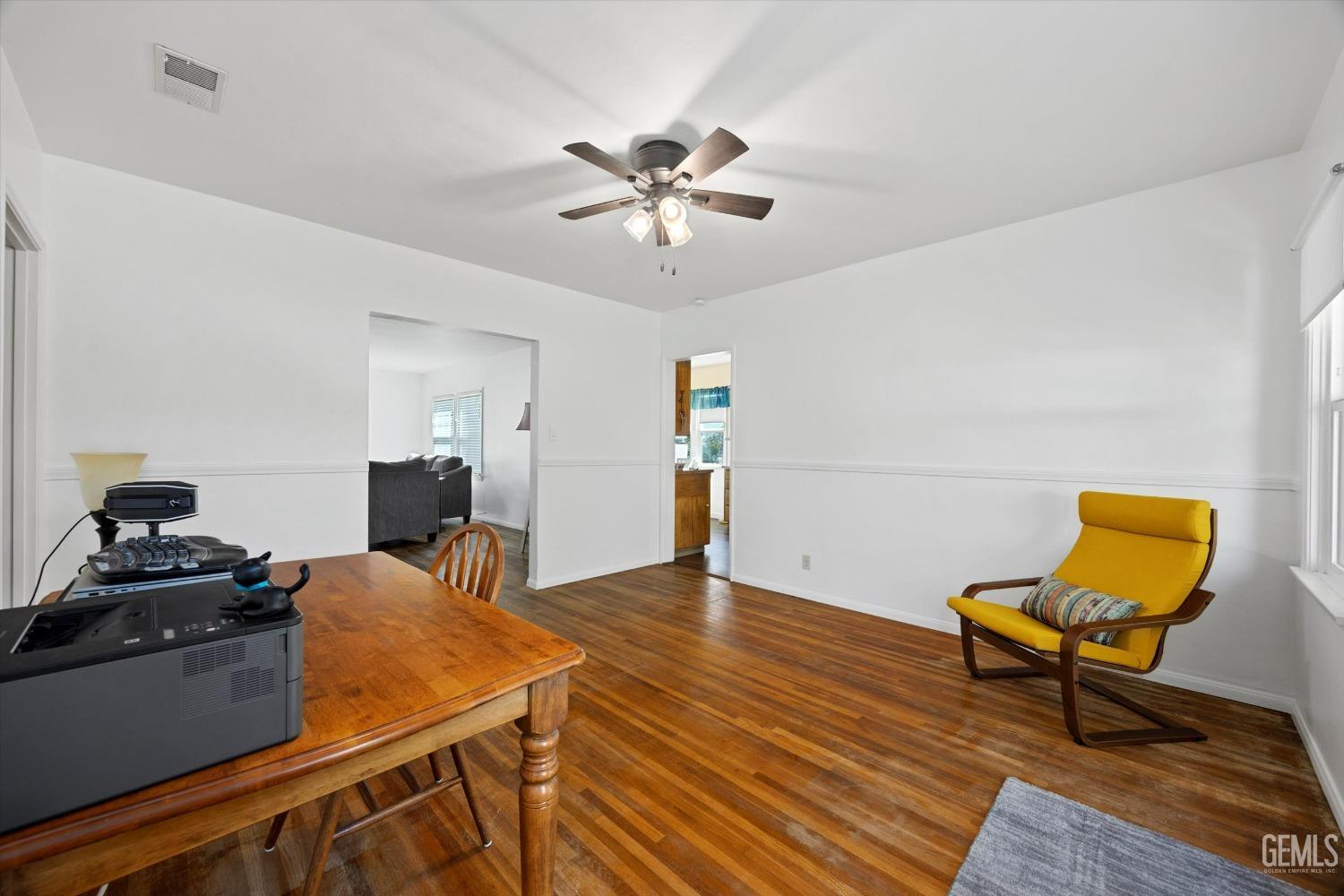 Undisclosed Address Bakersfield, CA 93305 - Photo 14 of 39 a workspace with furniture and wooden floor