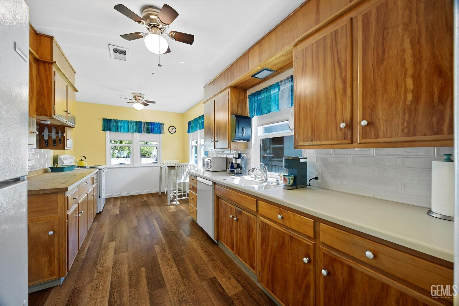 Undisclosed Address Bakersfield, CA 93305 - Photo 15 of 39 a kitchen with wooden cabinets and stainless steel appliances