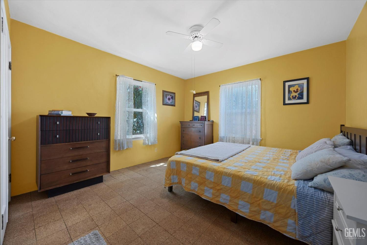 Undisclosed Address Bakersfield, CA 93305 - Photo 21 of 39 a bedroom with a bed and a dresser