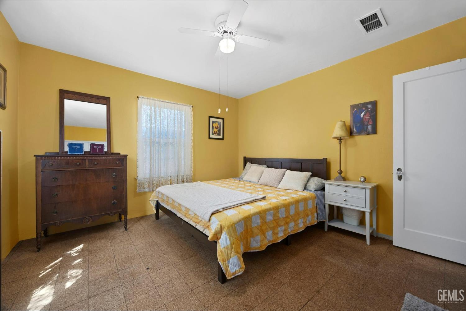 Undisclosed Address Bakersfield, CA 93305 - Photo 22 of 39 a bedroom with a bed and a dresser