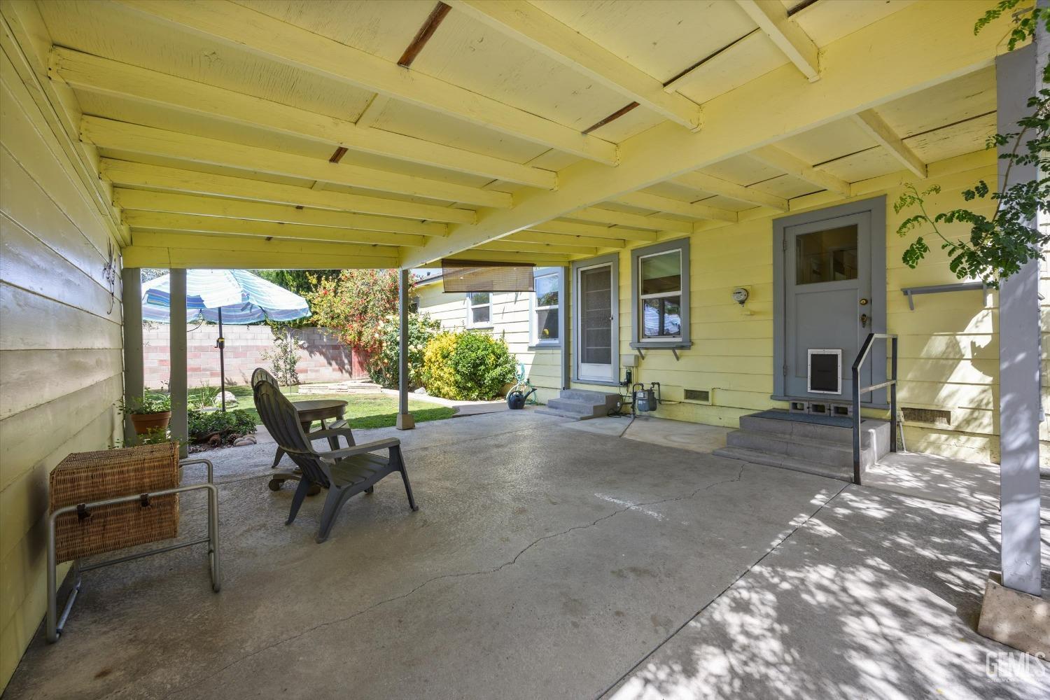 Undisclosed Address Bakersfield, CA 93305 - Photo 32 of 39 a view of a patio with table and chairs under an umbrella