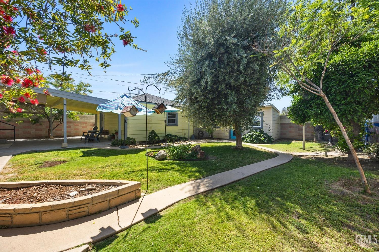 Undisclosed Address Bakersfield, CA 93305 - Photo 35 of 39 a view of a house with swimming pool and a yard