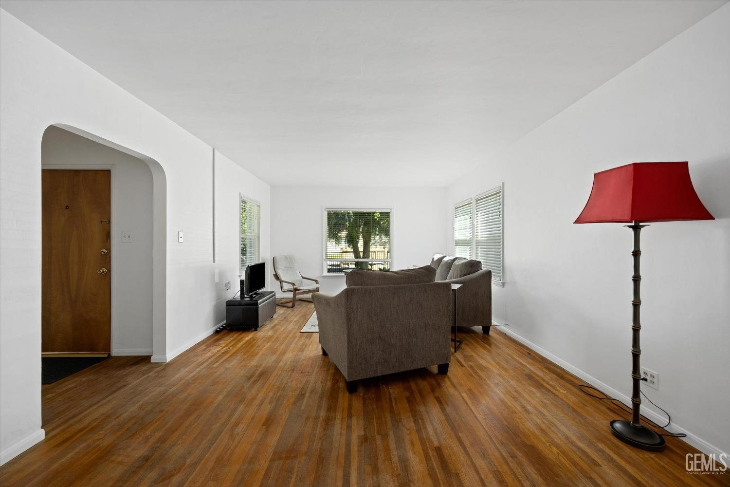 Undisclosed Address Bakersfield, CA 93305 - Photo 6 of 39 a living room with furniture and a wooden floor
