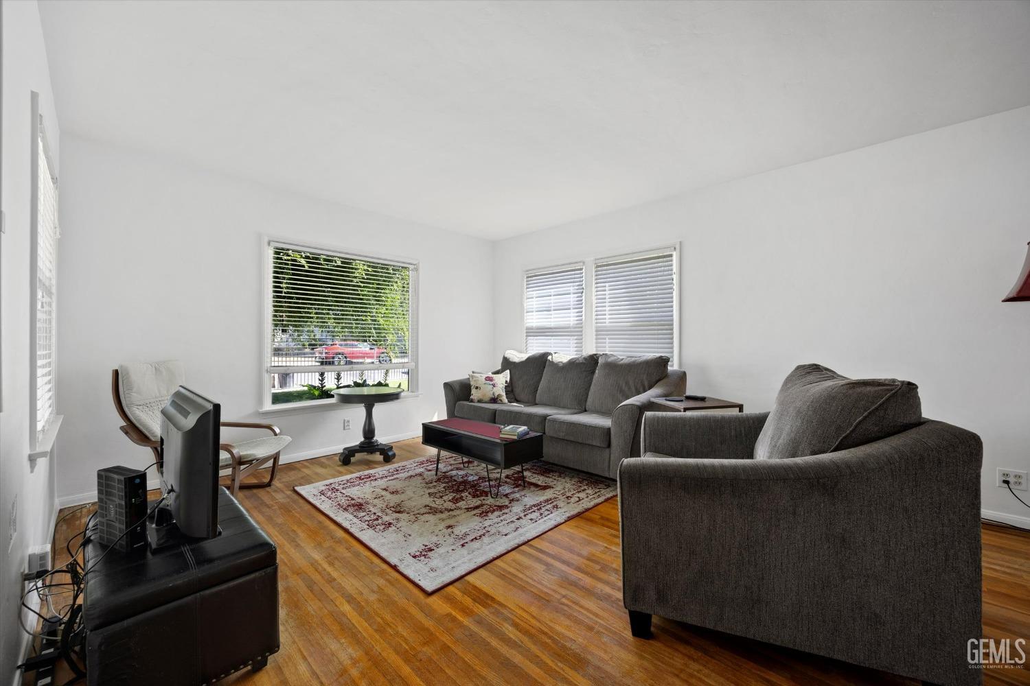 Undisclosed Address Bakersfield, CA 93305 - Photo 7 of 39 a living room with furniture and a flat screen tv