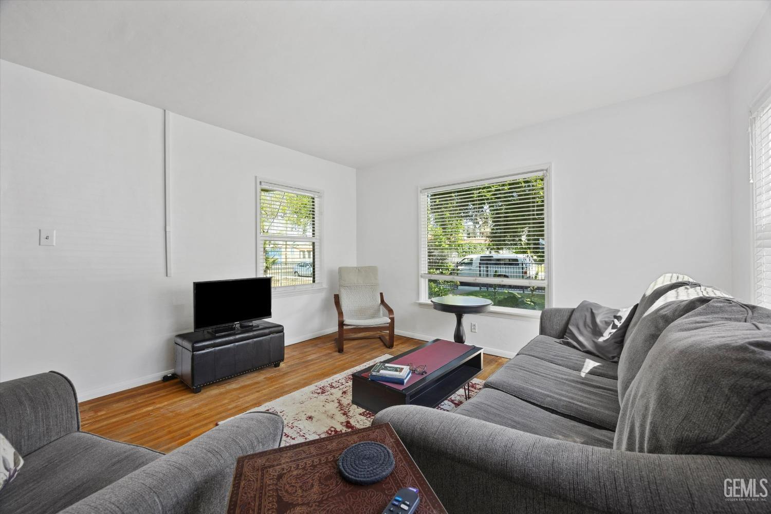Undisclosed Address Bakersfield, CA 93305 - Photo 9 of 39 a living room with furniture a window and a flat screen tv