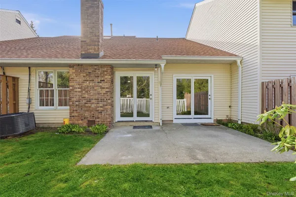 a front view of a house with a garden and yard