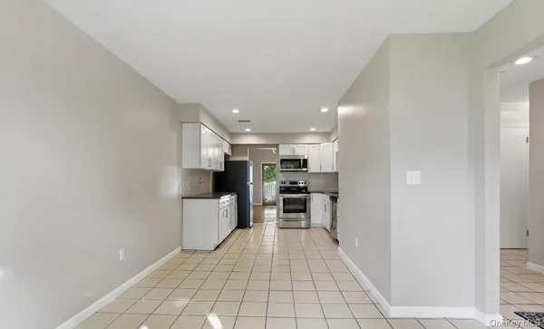 a view of a kitchen with a sink and a refrigerator