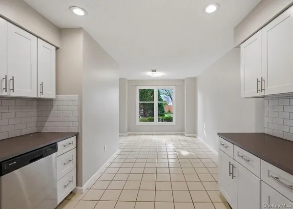 a open kitchen with granite countertop white cabinets and black appliances