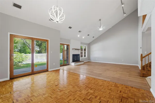 a view of an empty room with a fireplace and a window