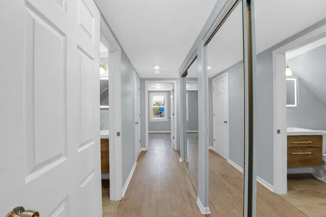 a view of hallway with wooden floor