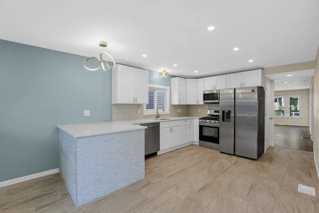 a kitchen with a refrigerator and a sink