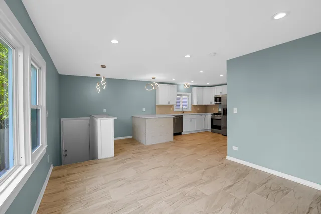 a view of kitchen with refrigerator stove microwave and cabinets