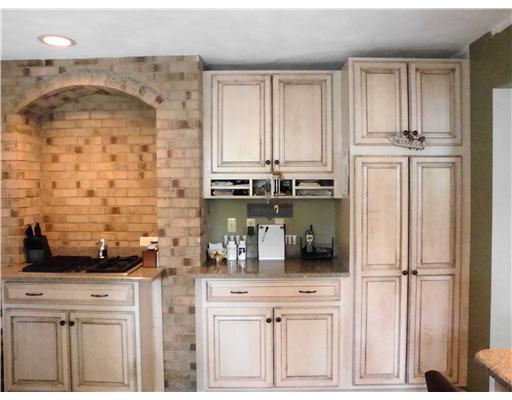 31 Allens Cove Road Charlestown, RI 02813 - Photo 4 of 10 Kitchen. Built in desk and Jennair stove all with quartz counter tops