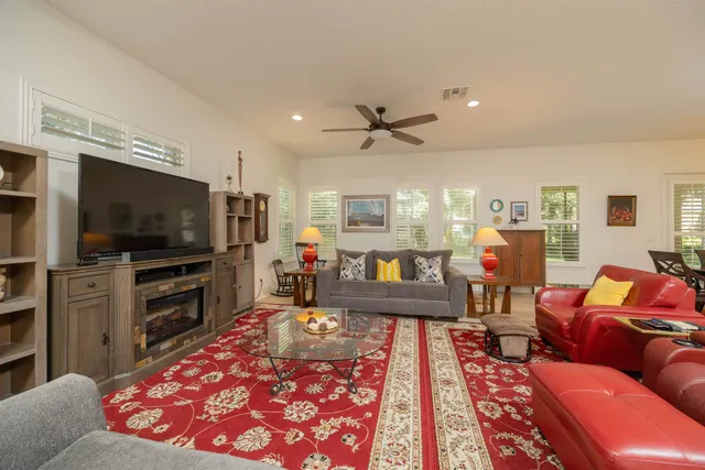 a kitchen with stainless steel appliances kitchen island granite countertop a refrigerator and a stove top oven