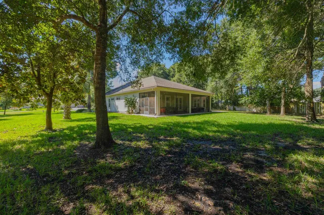 a bedroom with furniture and a large window