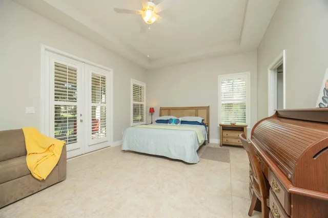 a spacious bedroom with a bed and a window