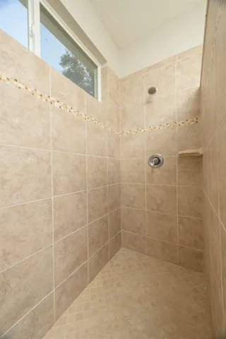 a bedroom with a bed and a chair