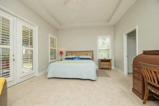 a spacious bathroom with a granite countertop sink a toilet and a mirror