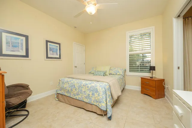 a white house with a small yard and large trees