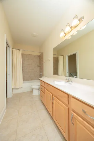 an aerial view of a house with a yard lake and outdoor seating