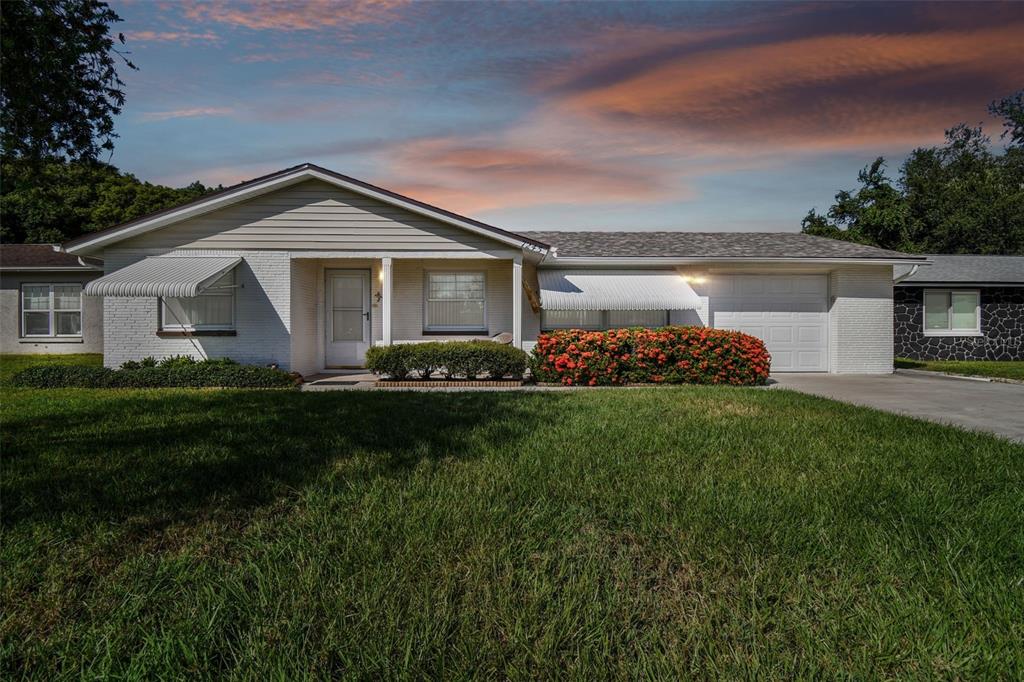7245 Exemplar Drive New Port Richey, FL 34655 - Photo 1 of 1 a front view of house with yard and green space