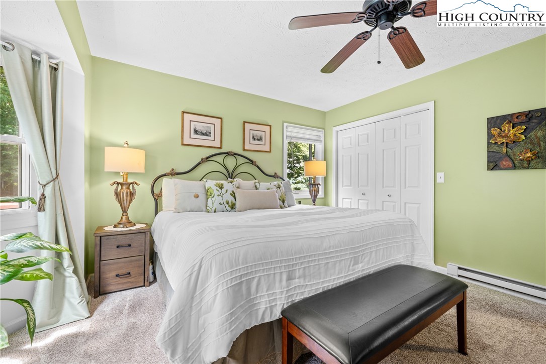 2587 Junaluska Road Boone, NC 28607 - Photo 18 of 47 a bedroom with a bed and a chandelier