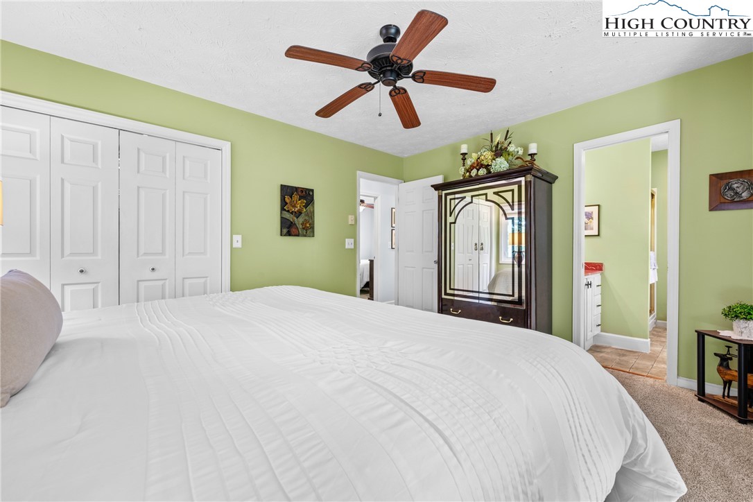 2587 Junaluska Road Boone, NC 28607 - Photo 19 of 47 a bedroom with a bed and a chandelier