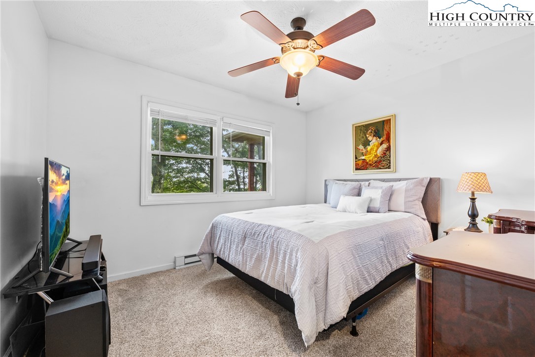 2587 Junaluska Road Boone, NC 28607 - Photo 24 of 47 a bedroom with a bed and a flat screen tv