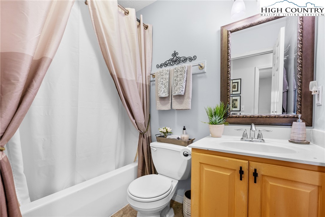 2587 Junaluska Road Boone, NC 28607 - Photo 26 of 47 a bathroom with a sink a toilet a mirror and shower