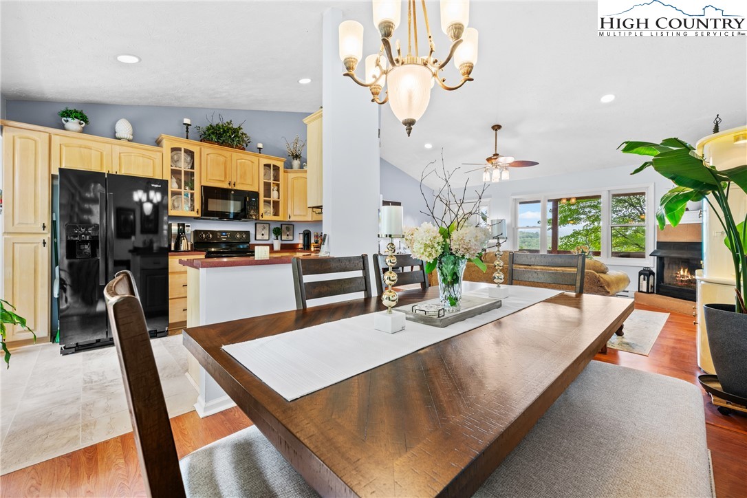 2587 Junaluska Road Boone, NC 28607 - Photo 10 of 47 a living room with stainless steel appliances furniture a chandelier and a view of kitchen