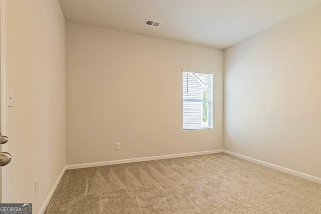 a view of a livingroom with a chandelier fan and a window