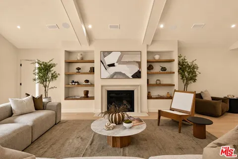a living room with furniture and view of kitchen