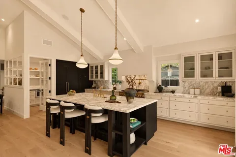 a dining room with furniture a rug and wooden floor