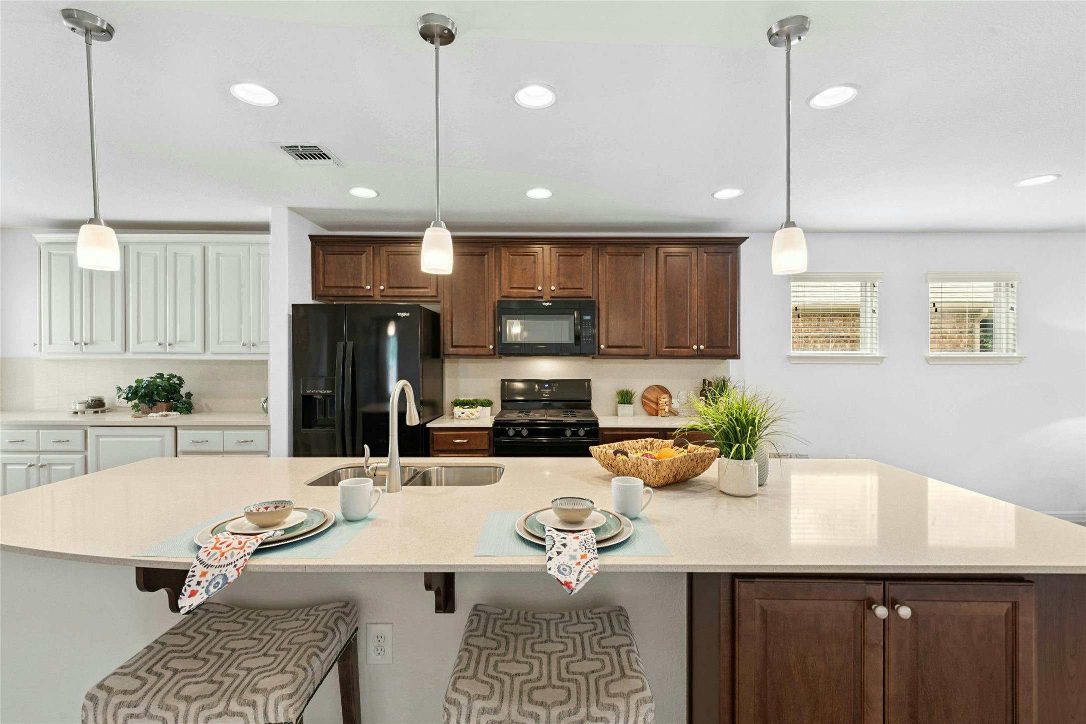 407 Fannin Court Georgetown, TX 78633 - Photo 12 of 40 a kitchen with stainless steel appliances kitchen island granite countertop a sink a stove a refrigerator and chairs